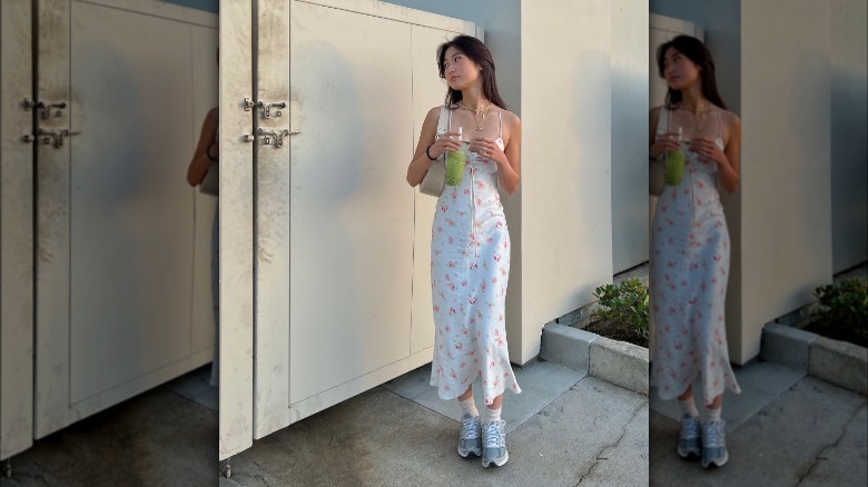 Woman wearing floral dress and running shoes