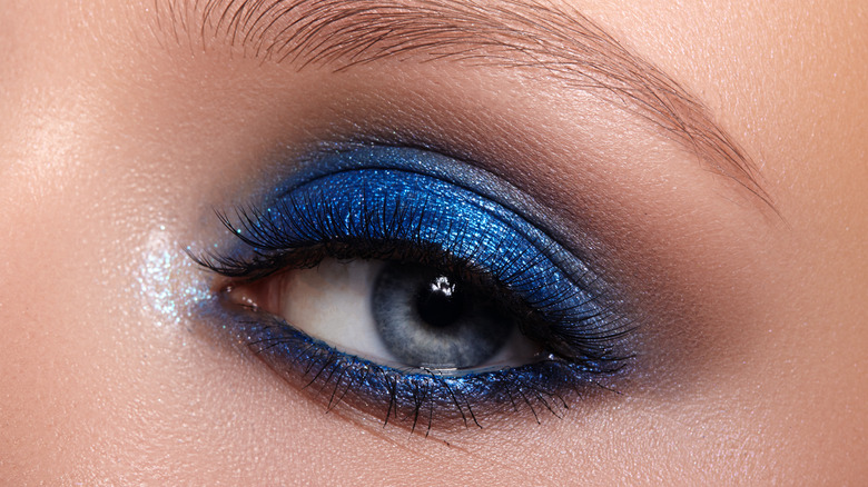 A woman wearing shimmer in the inner corner of her eyes