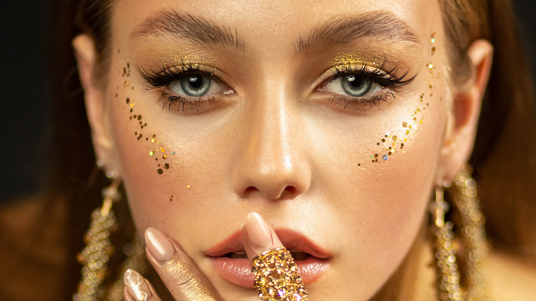 A woman wearing gold eye makeup
