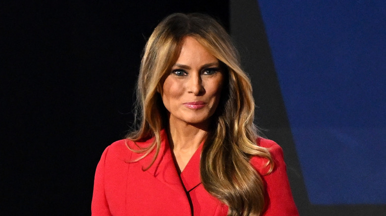 Melania Trump wearing a red jacket