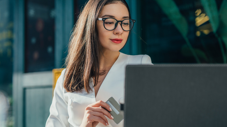 Woman shops online on patio