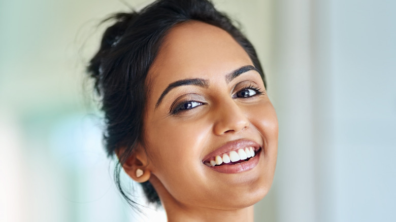 A woman with clear skin smiling