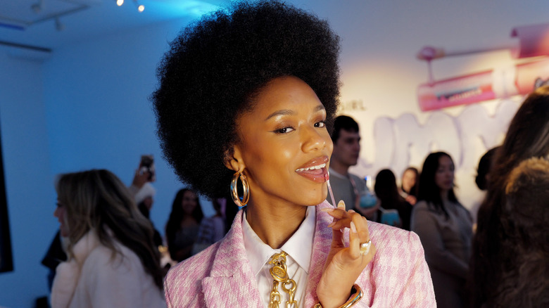 Woman applying lip gloss