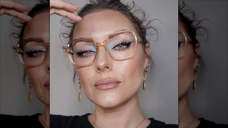 A woman wearing pink and blue eyeshadow