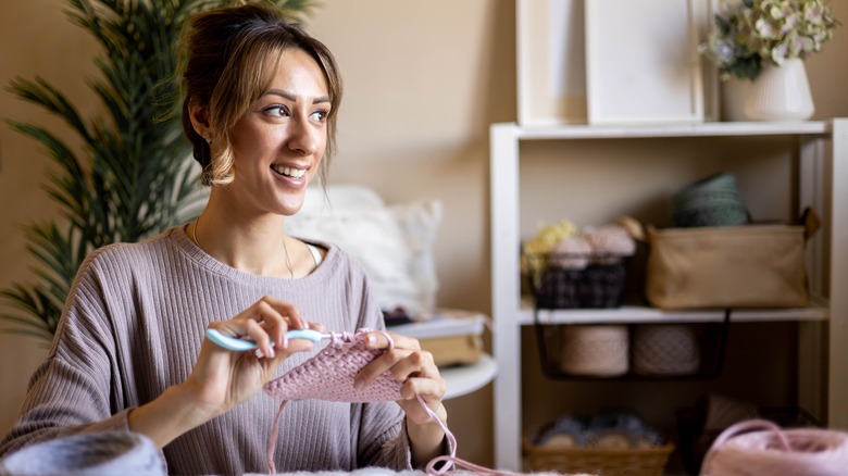 Woman crochets a simple square