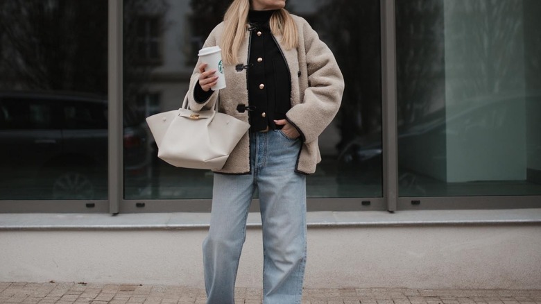 woman wearing coat and jeans