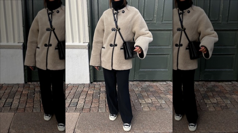 woman wearing shearling coat and trousers