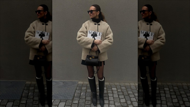 woman wearing coat and mini skirt