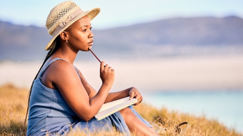 Woman journaling in a field