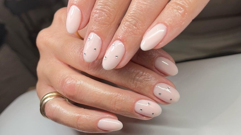 rounded flesh-toned nails with rhinestones