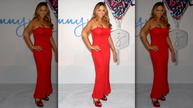 Mariah Carey posing in a red dress in 2011