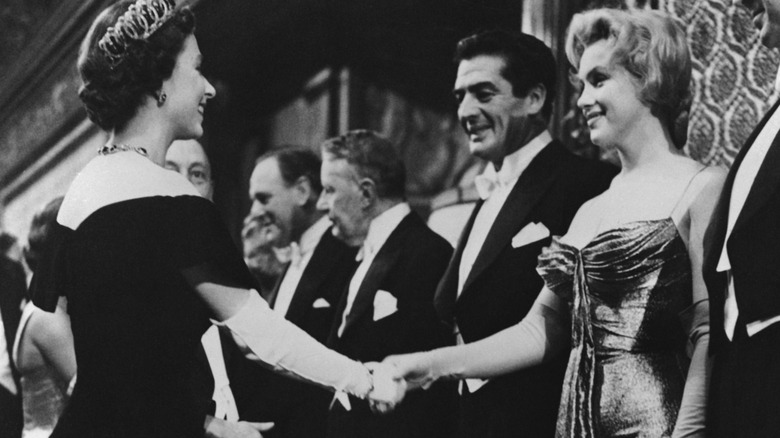 Marilyn Monroe meets Queen Elizabeth II.