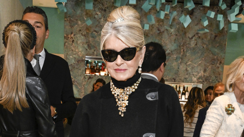 Martha Stewart posing in sunglasses and a turtleneck with a statement necklace