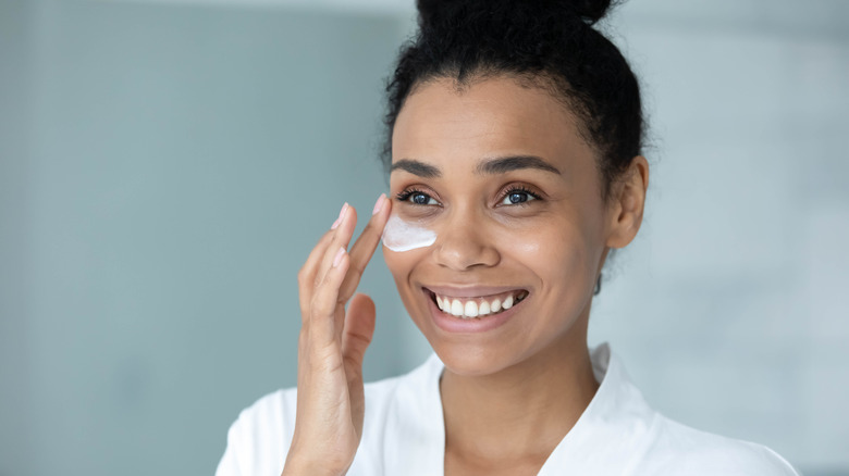 Woman adding hydration under eyes