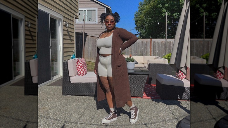 Woman wearing workout set with a white button up over it.