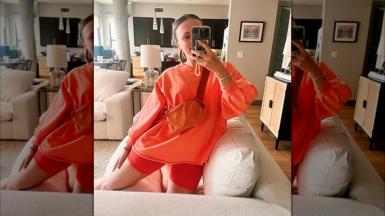 Girl wearing a matching sweatshirt and bike shorts.