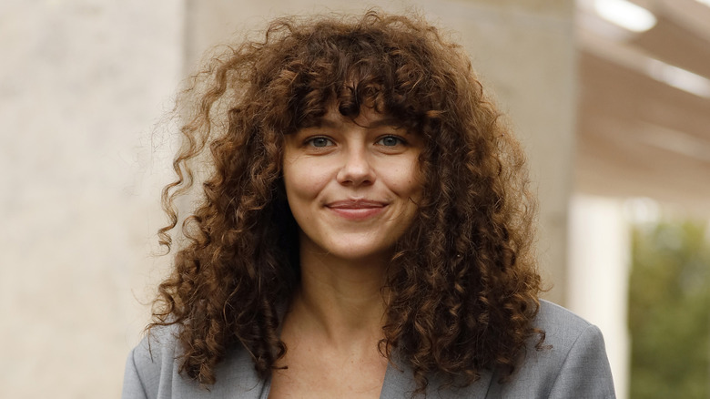 A woman with bangs and shoulder-length hair