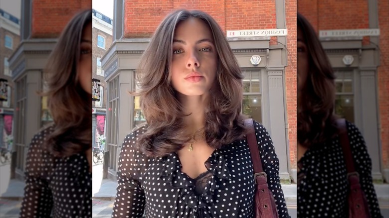 A woman with bouncy '90s-inspired layered