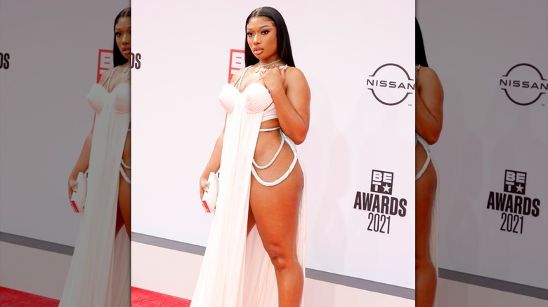 Megan Thee Stallion wearing a pale pink dress with extreme side slits at the 2021 BET awards