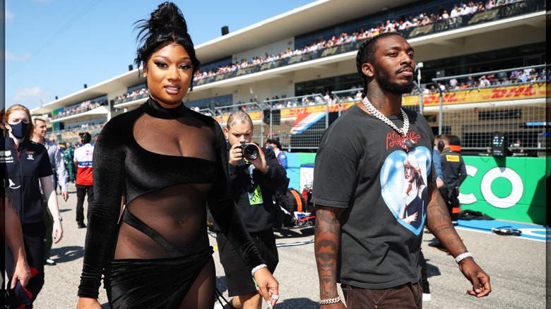 Megan Thee Stallion wearing a black outift while attending the F1 Grand Prix