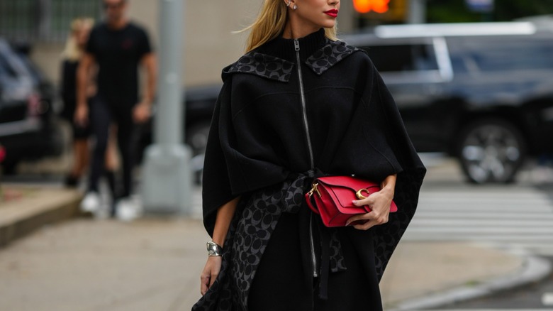 woman wearing cape coat