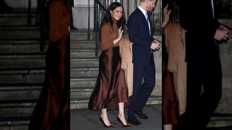 Meghan Markle wearing monochromatic brown outfit with her hair down.