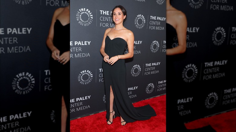 Meghan Markle wearing strapless black gown with black heeled sandals at the 2024 Paley Fall Honors Gala