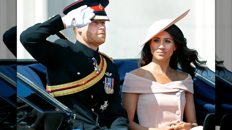 Meghan Markle in a pink dress and hat with Prince Harry at Trooping the Colour 2018.