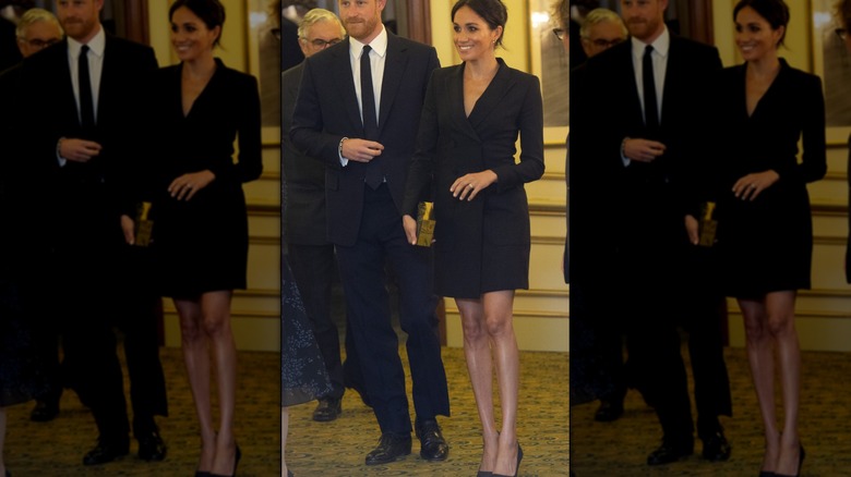 Meghan Markle pictured with Prince Harry wearing a short black blazer dress