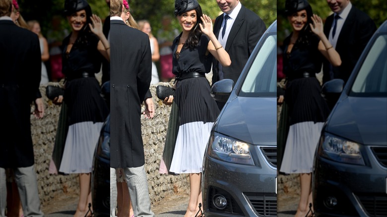 Meghan Markle wears a knee-length skirt and button-down top