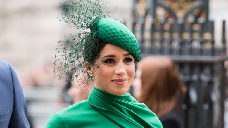 Meghan Markle wearing bright green with Prince Harry outside Westminster Abbey