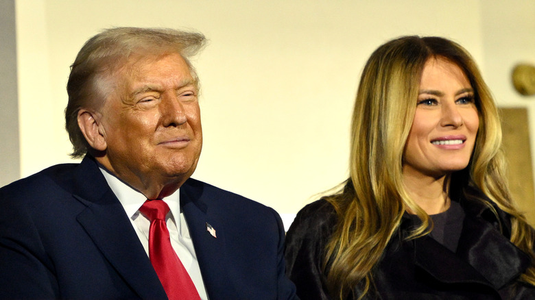 Donald Trump and Melania Trump smiling sitting next to each other