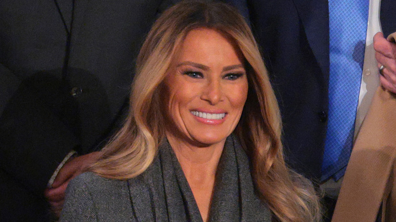Melania Trump wearing a gray jacket