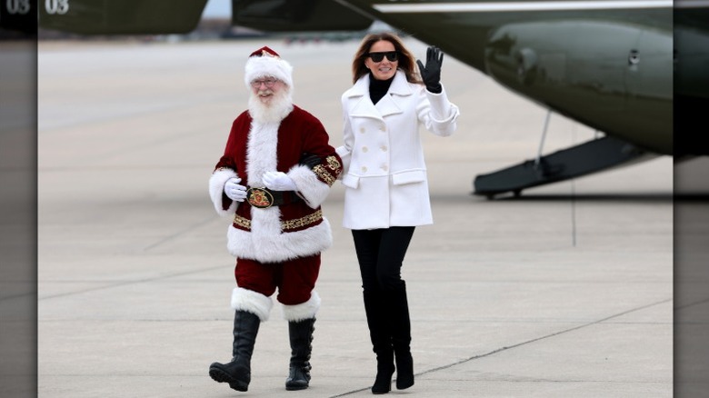 Melania Trump walks with a Santa Claus impersonator