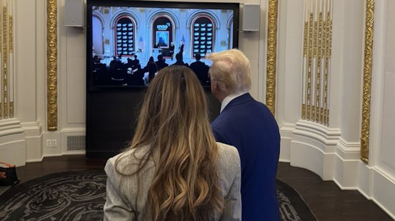 Melania Trump and Donald Trump from behind.