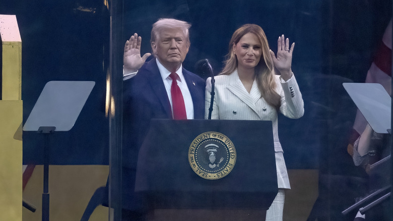 Melania Trump and Donald Trump waving from the podium