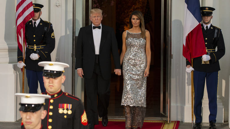 Donald and Melania Trump holding hands