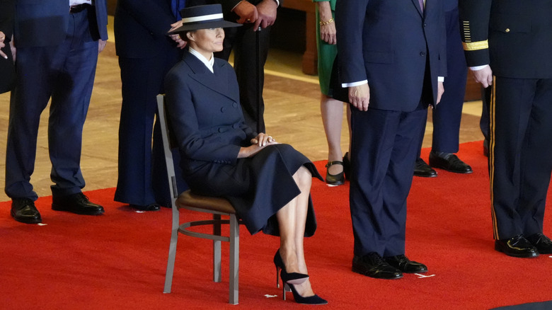 Melania Trump sitting on a chair wearing Manolo Blahniks at the inauguration in 2025