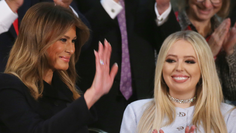 Melania Trump waving next to Tiffany Trump clapping