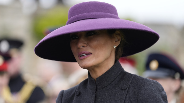 Melania Trump in a big purple hat