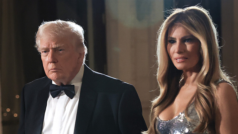 Donald and Melania photograhed holding hands at the New Year's Eve event at their Mar-a-Lago home