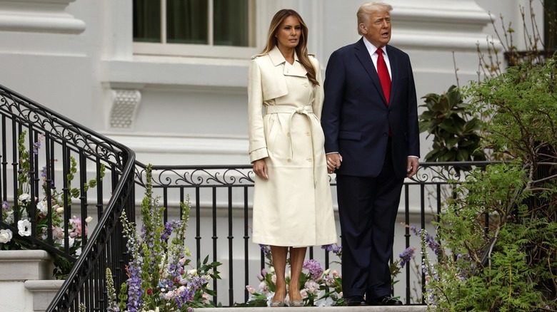 President Donald Trump and First Lady Melania Trump walk down from the Truman Balcony durning the White House Egg Roll on the South Lawn on April 21, 2025 in Washington, DC (2025)