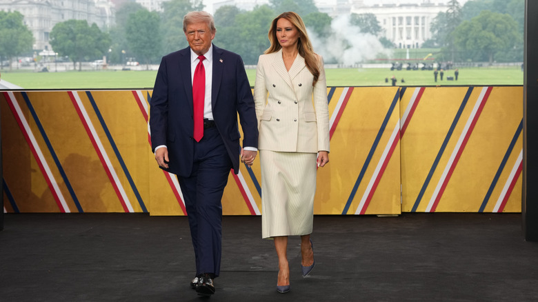 President Donald Trump and First Lady Melania Trump walk on stage during a celebration of the Army's 250th birthday on the National Mall on June 14, 2025 in Washington, DC (2025)
