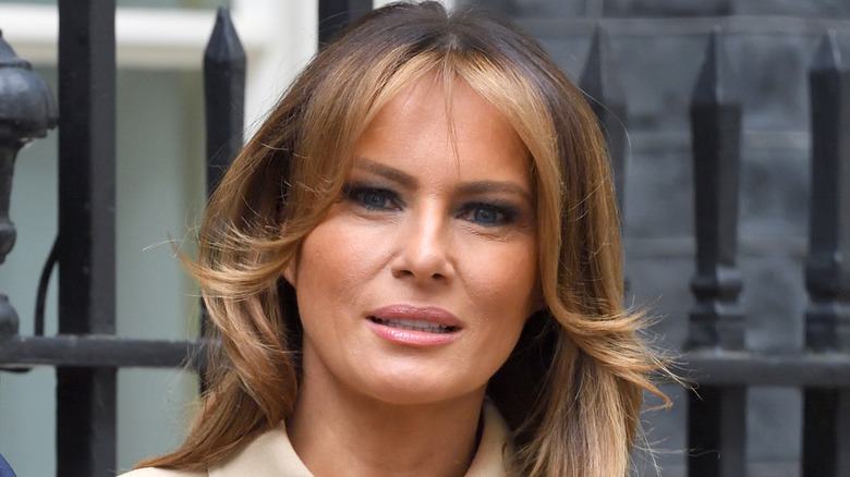 Melania Trump with blond curtain bangs and chocolate roots