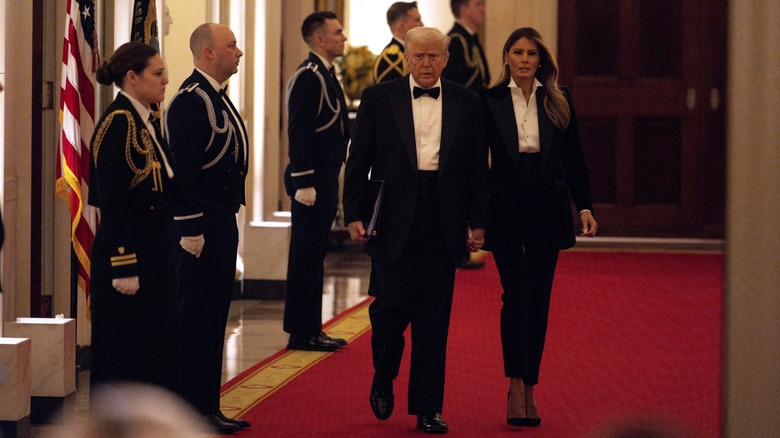 Melania Trump wearing a black-and-white suit alongside her husband, President Donald Trump, at the 2025 Governors Dinner