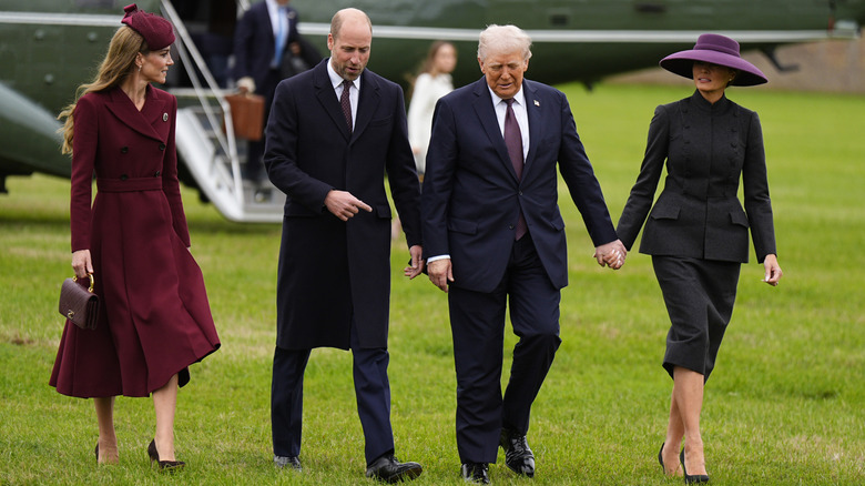 Melania Trump wearing a purple hat while walking with Donald Trump, Kate Middleton, and Prince William