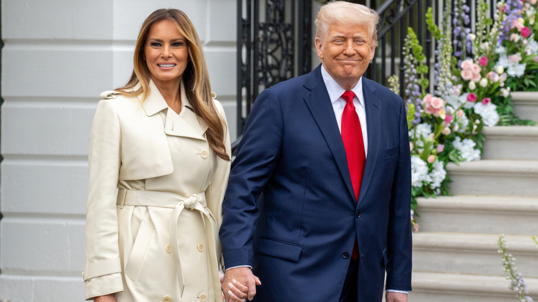 Melania Trump and Donald Trump holding hands