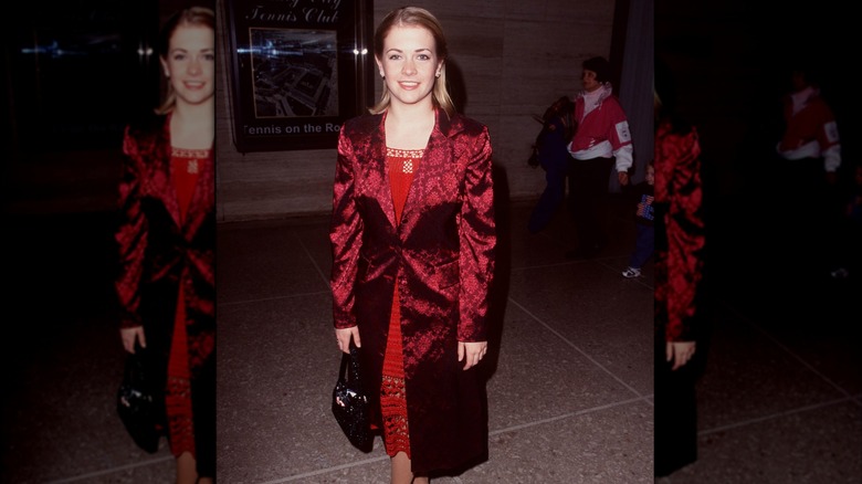 Melissa Joan Hart wearing a red dress and coat at a Christmas tree lighting in 1998