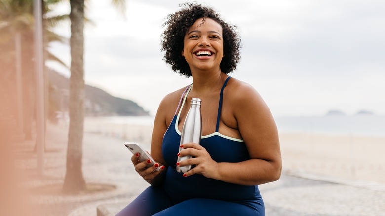Woman smiling with drink bottle