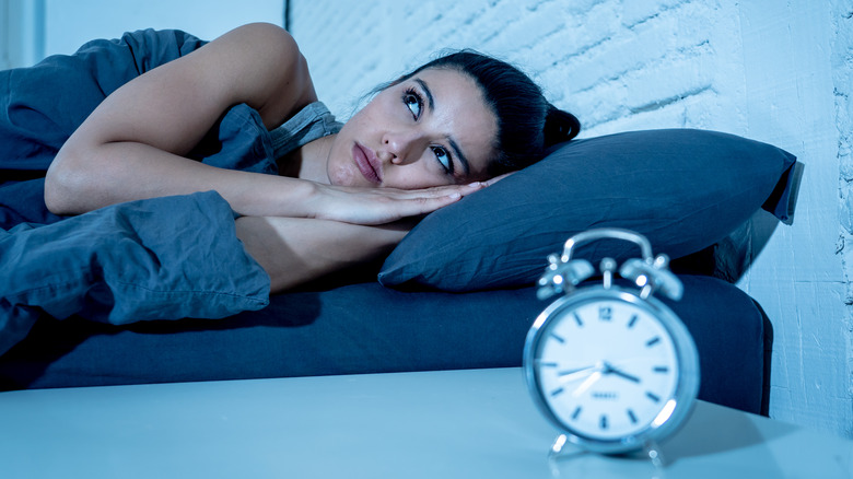 woman trying to sleep but can't